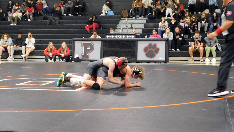 Intertwined roots prevalent in local HS wrestling rivalry